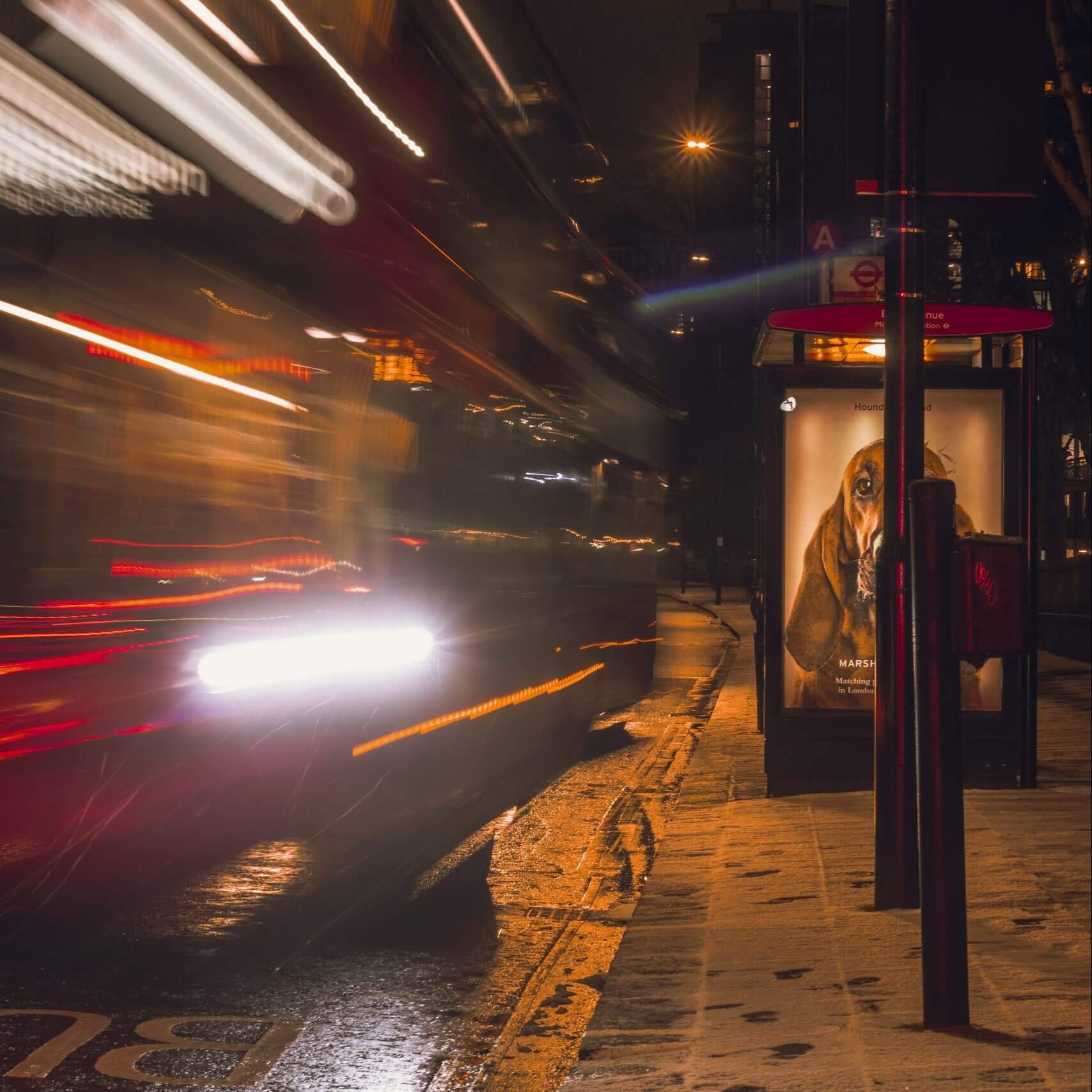 Cars Driving Past Bus Stop